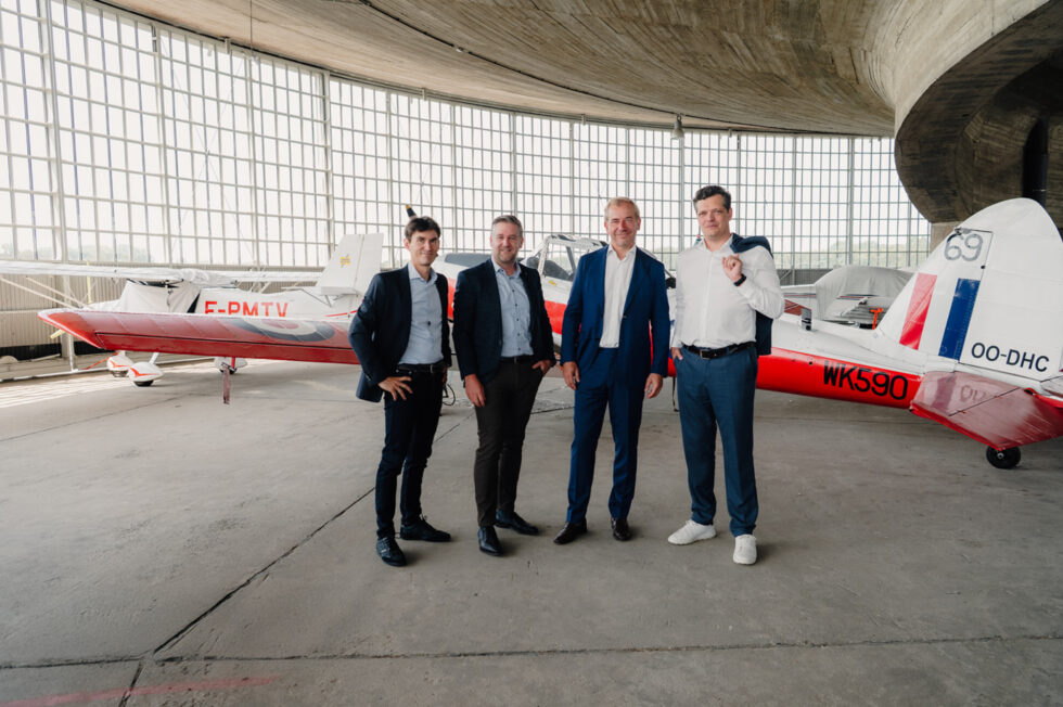 Team working taking a photo shoot in front of a plane