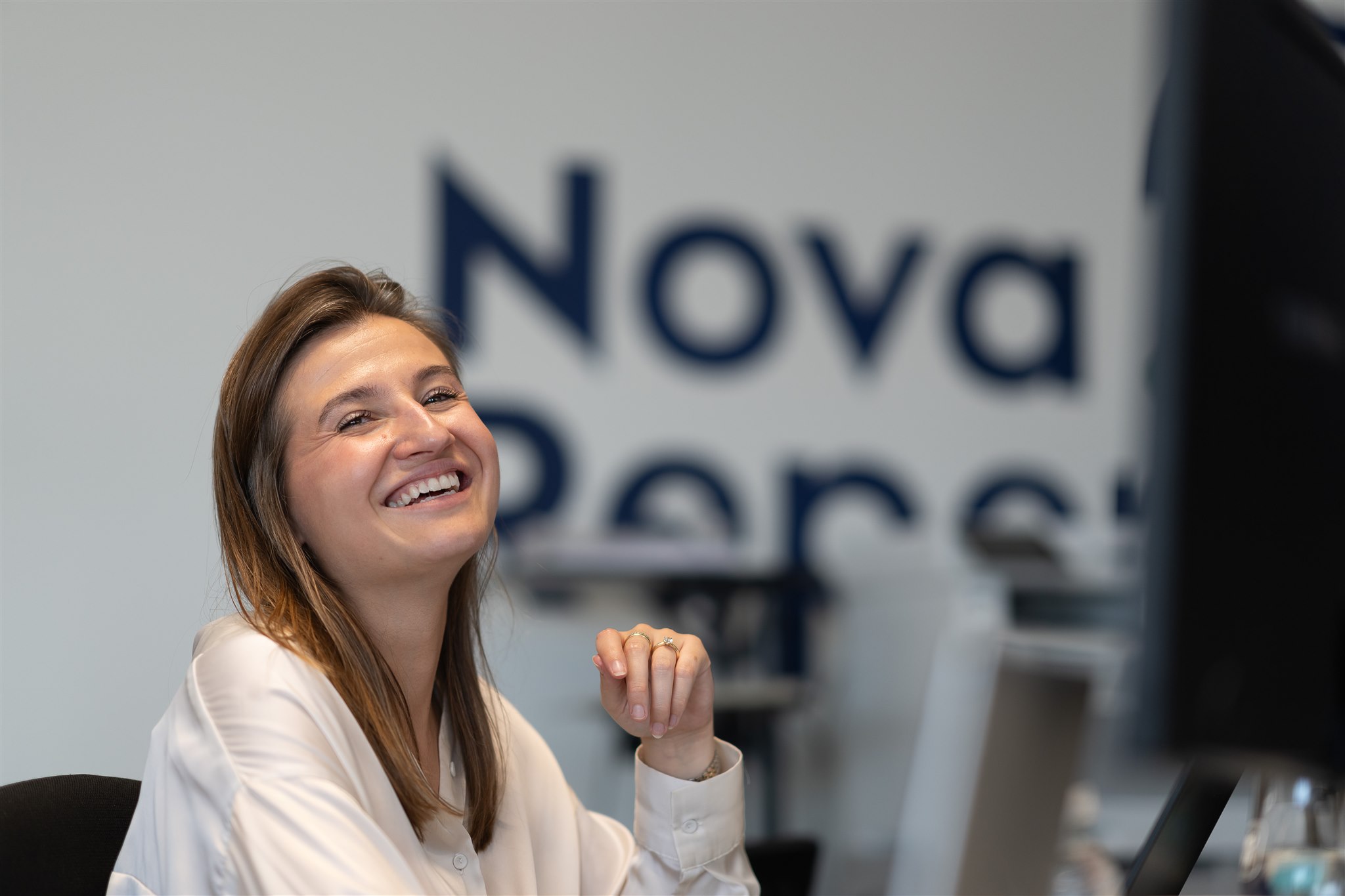 A smiling woman in an office environment